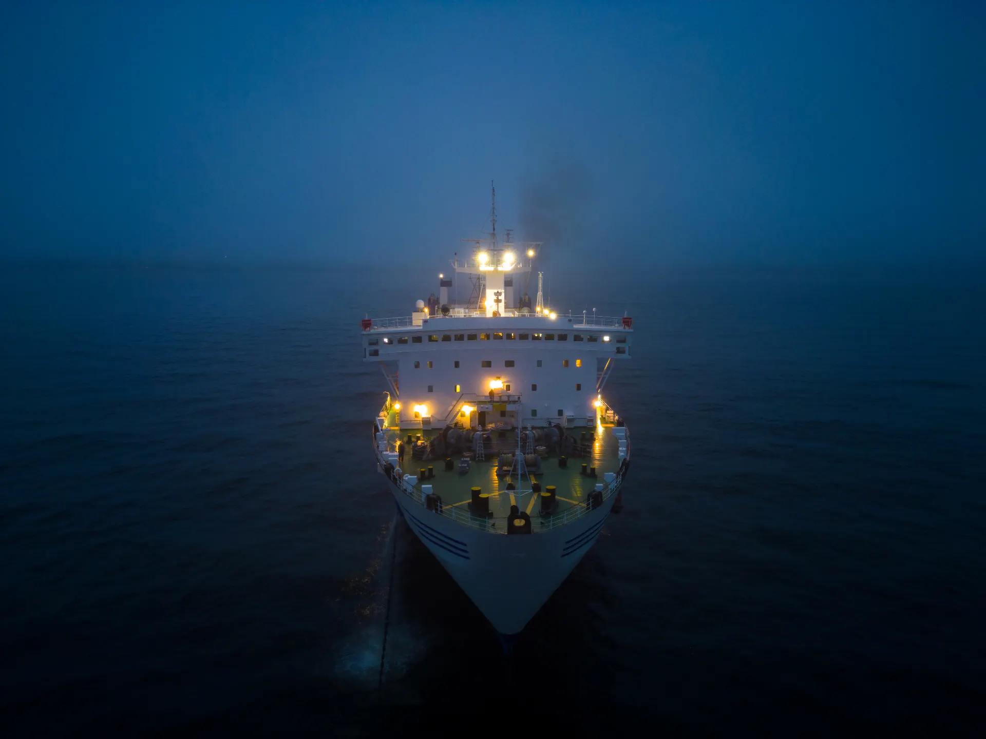 A ferry under way through fog, seen from above